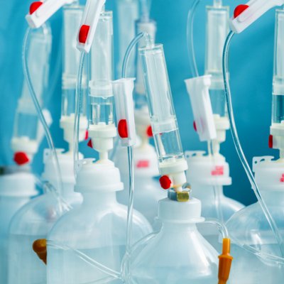 Plastic infusion sets clumped together with a blue backdrop